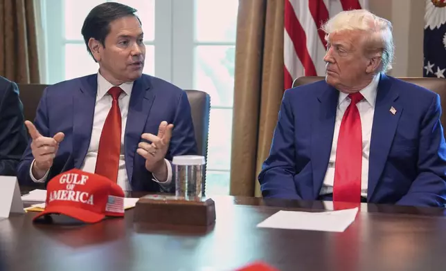 Secretary of State Marco Rubio speaks during a cabinet meeting at the White House, Wednesday, April 30, 2025, in Washington, as President Donald Trump look on. (AP Photo/Evan Vucci)