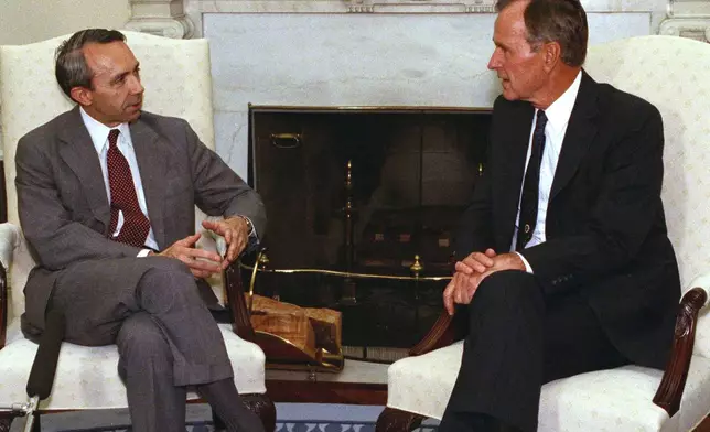 FILE - President George H.W. Bush talks with Supreme Court nominee Judge David Souter in the Oval Office of the White House, Sept. 13, 1990. (AP Photo/Charles Tasnadi, File)