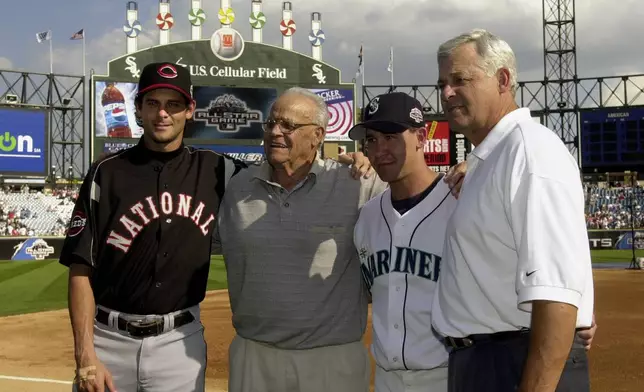 FILE - In this July 15, 2003 file photo, then-Cincinnati Reds' Aaron Boone, left, and his brother, Bret, second from right, pose with their grandfather, Ray, second from left, and father, Bob, right, before the 74th Major League Baseball All-Star Game at U.S. Cellular Field in Chicago. (AP Photo/Mark Duncan, File)