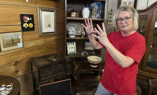 Michelle Hackworth discusses U.S. politics standing in her Paintsville, Ky., antiques store, Friday, May 16, 2025. (AP Photo/Bill Barrow)
