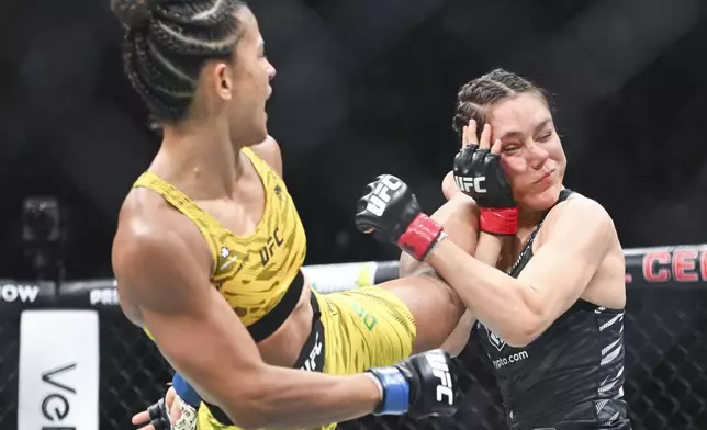 Natalia Silva, left, lands a kick to the head of Alexa Grasso, right, during their UFC 315 flyweight mixed martial arts bout in Montreal, Saturday, May 10, 2025. (Graham Hughes/The Canadian Press via AP)