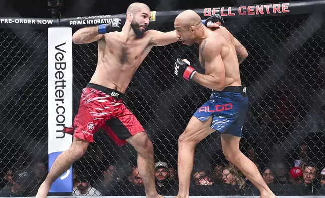 Jose Aldo, right, and Aiemann Zahabi, left, trade blows during their UFC 315 featherweight mixed martial arts bout in Montreal, Saturday, May 10, 2025. (Graham Hughes/The Canadian Press via AP)