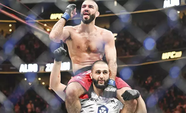 Aiemann Zahabi, top, reacts following his win over Jose Aldo during their UFC 315 mixed martial arts featherweight bout in Montreal, Saturday, May 10, 2025. (Graham Hughes/The Canadian Press via AP)