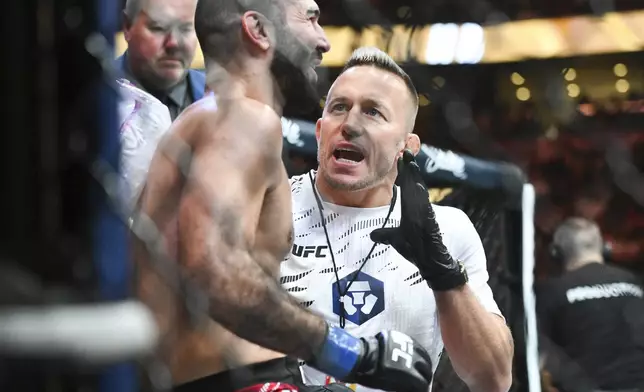 Georges St-Pierre, right, coaches Aiemann Zahabi, left, during his UFC 315 mixed martial arts featherweight bout against Jose Aldo in Montreal, Saturday, May 10, 2025. (Graham Hughes/The Canadian Press via AP)