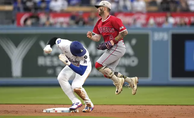 Los Angeles Dodgers' Shohei Ohtani is forced out at second by Los Angeles Angels shortstop Zach Neto during the first inning of a baseball game Friday, May 16, 2025, in Los Angeles. (AP Photo/Mark J. Terrill)