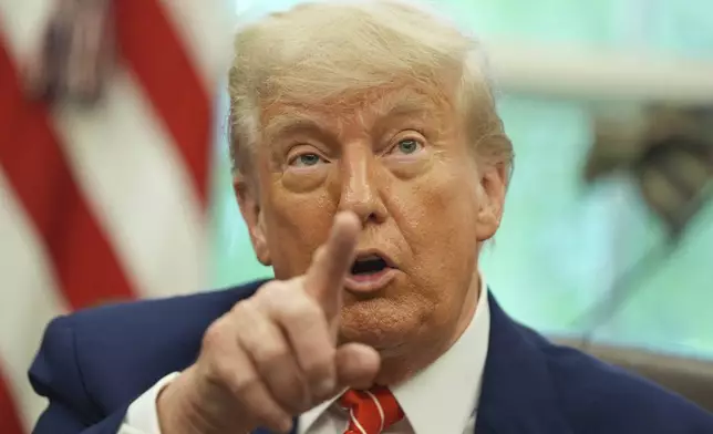 President Donald Trump gestures as he speaks with reporters after announcing a trade deal with United Kingdom in the Oval Office of the White House, Thursday, May 8, 2025, in Washington. (AP Photo/Evan Vucci)