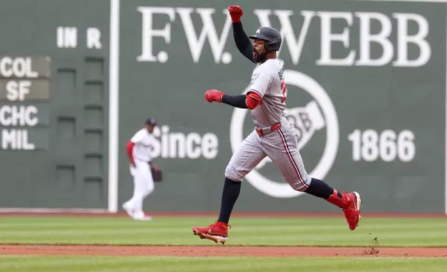 Minnesota Twins' Byron Buxton gestures as he runs the bases after hitting a home run during the first inning of a baseball game against the Boston Red Sox, Sunday, May 4, 2025, in Boston. (AP Photo/Mark Stockwell)