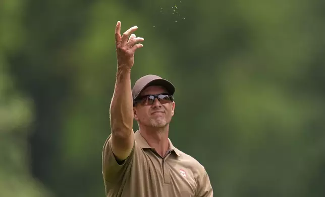Adam Scott, of Australia, checks the wind on the second hole during the final round of the PGA Championship golf tournament at the Quail Hollow Club, Sunday, May 18, 2025, in Charlotte, N.C. (AP Photo/George Walker IV)