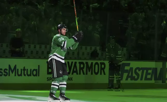 Dallas Stars right wing Mikko Rantanen acknowleges cheers from fans after Game 3 of a second-round NHL hockey playoff series against the Winnipeg Jets in Dallas, Sunday, May 11, 2025. (AP Photo/Julio Cortez)