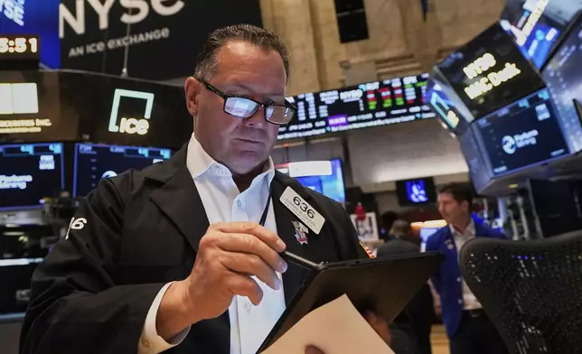 Trader Edward Curran works on the floor of the New York Stock Exchange, Wednesday, May 7, 2025. (AP Photo/Richard Drew)