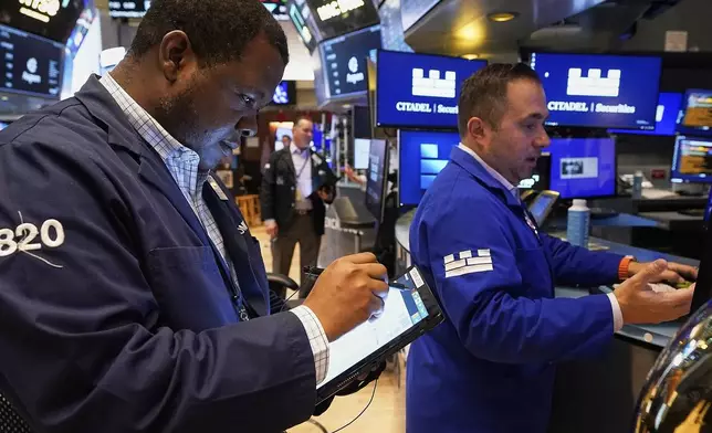 Trader Thomas Lee, left, and specialist Genarro Saporito work on the floor of the New York Stock Exchange, Thursday, May 8, 2025. (AP Photo/Richard Drew)