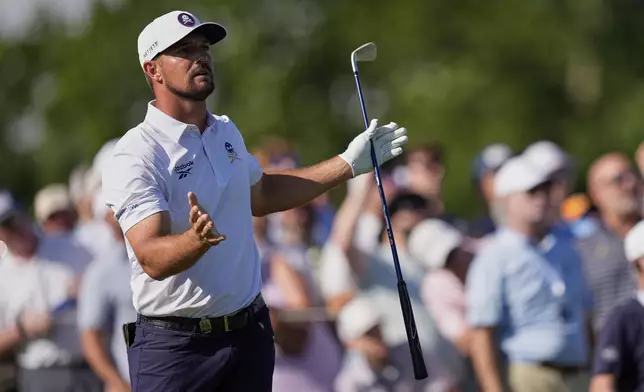 Bryson DeChambeau reacts after hitting his tee shot into the water on the 17th hole during the third round of the PGA Championship golf tournament at the Quail Hollow Club, Saturday, May 17, 2025, in Charlotte, N.C. (AP Photo/George Walker IV)