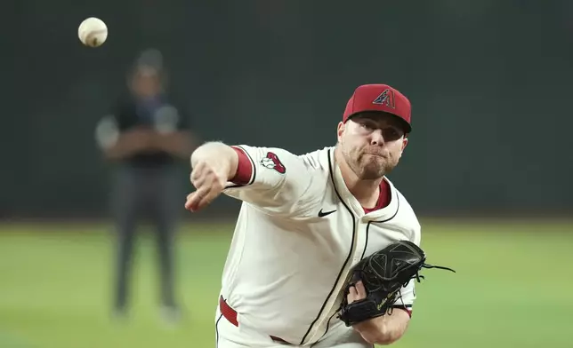 Arizona Diamondbacks starting pitcher Corbin Burnes warms up prior to a baseball game against the Pittsburgh Pirates Tuesday, May 27, 2025, in Phoenix. (AP Photo/Ross D. Franklin)