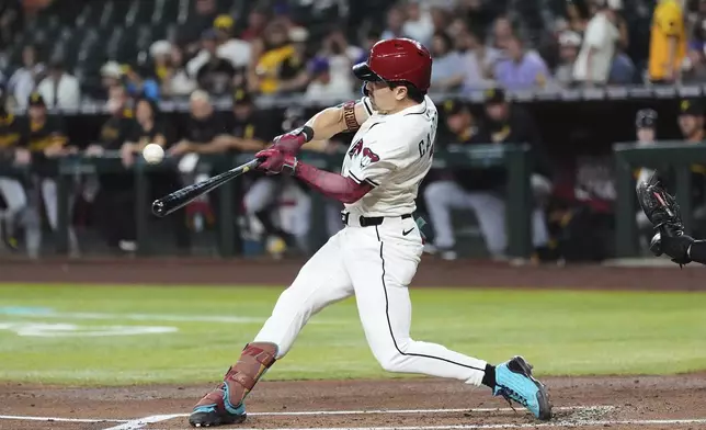 Arizona Diamondbacks' Corbin Carroll connects for a home run against the Pittsburgh Pirates during the first inning of a baseball game Tuesday, May 27, 2025, in Phoenix. (AP Photo/Ross D. Franklin)