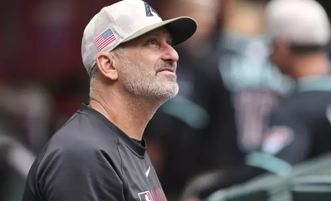 Arizona Diamondbacks manager Torey Lovullo pauses in the dugout prior to a baseball game against the Colorado Rockies Saturday, May 17, 2025, in Phoenix. (AP Photo/Ross D. Franklin)
