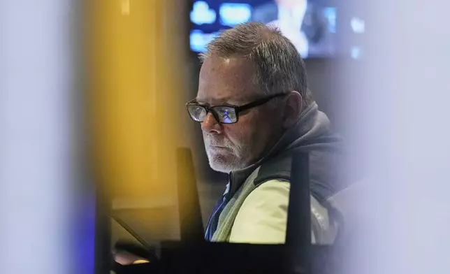 Trader Michael Conlon works on the floor of the New York Stock Exchange, Tuesday, May 20, 2025. (AP Photo/Richard Drew)