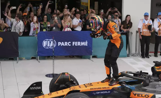 McLaren driver Oscar Piastri of Australia stands on top of his car after winning the Formula One Miami Grand Prix auto race Sunday, May 4, 2025, in Miami Gardens. Fla. (AP Photo/Rebecca Blackwell)
