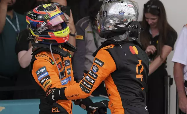 McLaren drivers Oscar Piastri of Australia, left, and Lando Norris of Britain celebrate after a first and second place finish in the Formula One Miami Grand Prix auto race Sunday, May 4, 2025, in Miami Gardens. Fla. (AP Photo/Rebecca Blackwell)