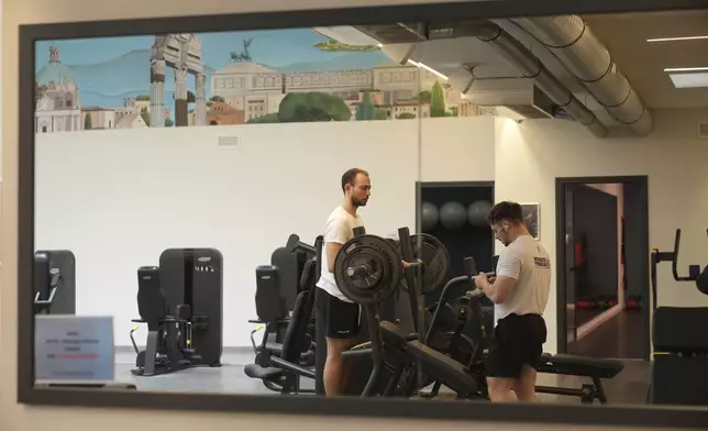 Personal trainer Valerio Masella, 26, who trained Robert Francis Prevost before the cardinal became Pope Leo XIV, works at his gym near the Vatican, Wednesday, May 21, 2025. (AP Photo/Alessandra Tarantino)
