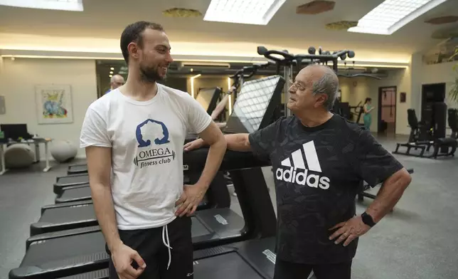 Personal trainer Valerio Masella, 26, who trained Robert Francis Prevost before the cardinal became Pope Leo XIV, shares a word with Vincenzo pagano, a gym user at his gym near the Vatican, Wednesday, May 21, 2025. (AP Photo/Alessandra Tarantino)