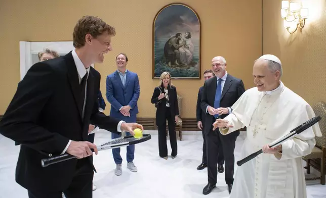 Italy's Jannik Sinner, left, shares a light moment with Pope Leo XIV on the occasion of their meeting at the Vatican, Wednesday, May 14, 2025. (Vatican Media via AP)