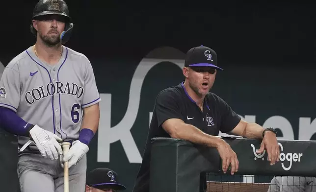 Colorado Rockies interim manager Warren Schaeffer, right, looks on as Kyle Farmer (6) prepares to bat during the sixth inning of a baseball game against the Texas Rangers, Wednesday, May 14, 2025, in Arlington, Texas. (AP Photo/LM Otero)