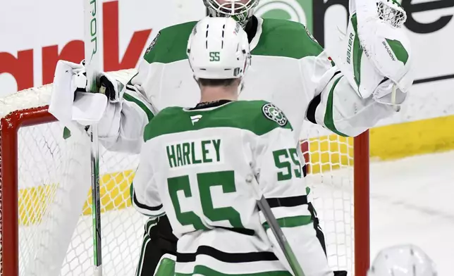 Dallas Stars goaltender Jake Oettinger (29) celebrates the win over the Winnipeg Jets with Thomas Harley (55) in NHL playoff hockey action in Winnipeg, Canada, Wednesday, May 7, 2025. (Fred Greenslade/The Canadian Press via AP)