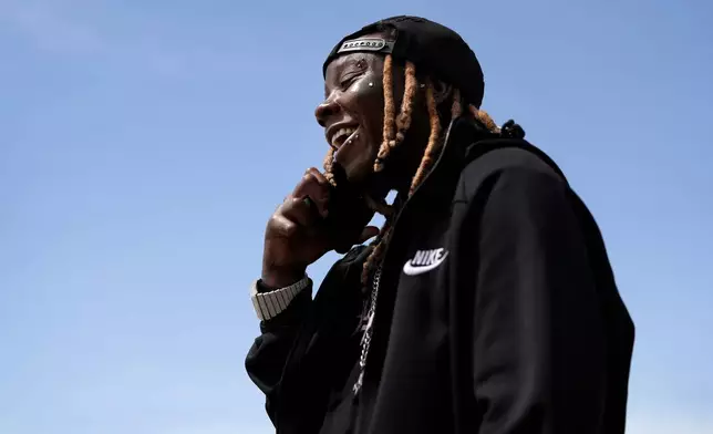 Tazz Webster, who ultimately wound up homeless after an apartment manager allegedly ridiculed and shoved him because he is transgender, speaks on the phone, April 9, 2025, in St. Louis. (AP Photo/Jeff Roberson)