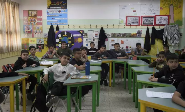 Students sit at their desks at the UNRWA Boys' School run by the U.N. agency for Palestinian refugees in the Shuafat Refugee Camp in east Jerusalem, in the Shuafat Refugee Camp in east Jerusalem, Tuesday, April 29, 2025. (AP Photo/Maya Alleruzzo)