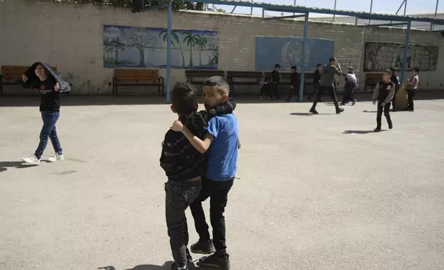 Students play outside during recess at the UNRWA Boys' School run by the U.N. agency for Palestinian refugees in the Shuafat Refugee Camp in east Jerusalem, Tuesday, April 29, 2025. (AP Photo/Maya Alleruzzo)