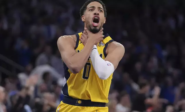 Indiana Pacers guard Tyrese Haliburton (0) makes a choke motion towards the New York Knicks after hitting a shot at the end of the fourth quarter of Game 1 of the NBA basketball Eastern Conference final, Wednesday, May 21, 2025, in New York. (AP Photo/Frank Franklin II)