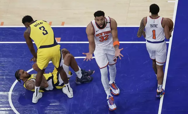 New York Knicks center Karl-Anthony Towns (32) reacts during the third quarter of Game 1 of the NBA basketball Eastern Conference final against the Indiana Pacers, Wednesday, May 21, 2025, in New York. (AP Photo/Adam Hunger)