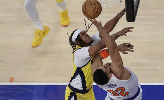 New York Knicks center Karl-Anthony Towns (32) is fouled while shooting by Indiana Pacers center Myles Turner (33) during the second quarter of Game 1 of the NBA basketball Eastern Conference final, Wednesday, May 21, 2025, in New York. (AP Photo/Adam Hunger)