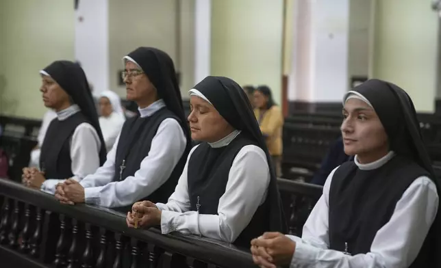 Nuns pray during morning Mass at the Santa Maria Cathedral, the episcopal see of the Diocese of Chiclayo, Peru, where newly elected Pope Leo XIV served as bishop, Friday, May 9, 2025. (AP Photo/Guadalupe Pardo)