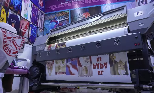 Posters of newly elected Pope Leo XIV are printed for sale at a shop in Lima, Peru, Friday, May 9, 2025. (AP Photo/Martin Mejia)