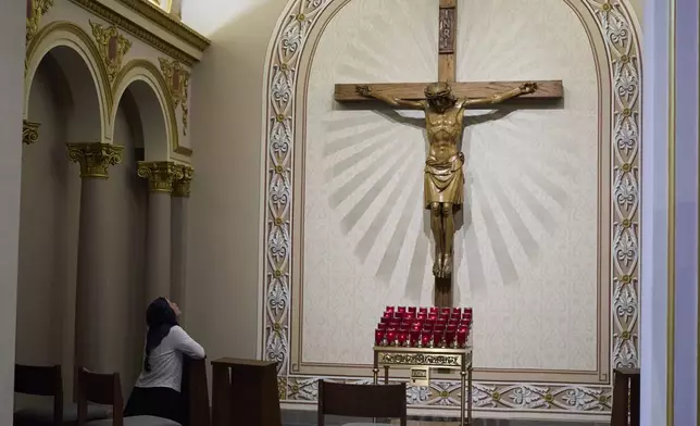 A woman prays in a chapel after a Mass in honor of Pope Leo XIV at the Cathedral of Incarnation, Friday, May 9, 2025, in Nashville, Tenn. (AP Photo/George Walker IV)