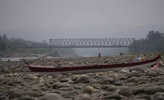 A boat stands still at the dry Chenab river after the water was halted from a dam, at Akhnoor, on the outskirts of Jammu, India, Monday, May 5, 2025. (AP Photo/Channi Anand)