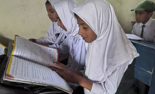 Students attend their class in Aligarh School and College of Commerce and Science in Dara Batang during a government's organized trip for media to Bella Noor Shah, a mountainous village near Muzaffarabad, the capital of Pakistan administered Kashmir, Monday, May 5, 2025. (AP Photo/Muhammad Yousuf, Pool)