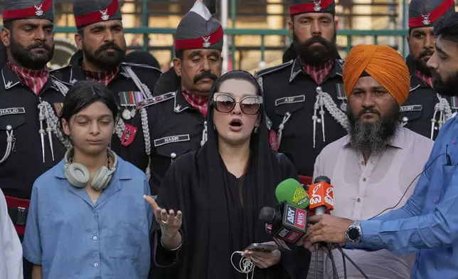 Mushaal Hussein, center, the wife of a top Kashmiri rebel leader, Mohammed Yasin Malik, talks to media as her daughter Razia Sultan, left, watches, at the Wagah, a joint post on the Pakistan and India border, near Lahore, Pakistan, Monday, May 5, 2025. (AP Photo/K.M. Chaudary)