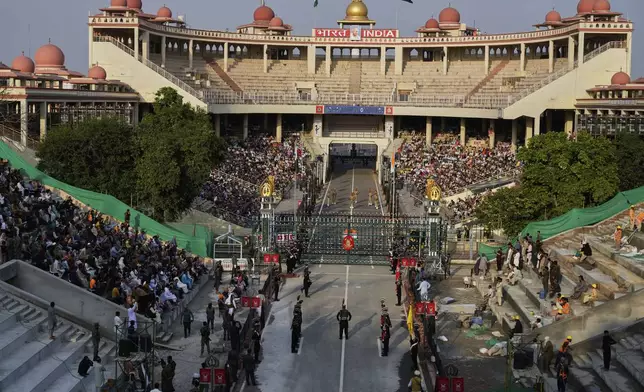 Pakistan's Rangers soldiers, bottom, and Indian Border Security Forces soldiers, top, parade during a daily closing ceremony at the Wagah, a joint post on the Pakistan and India border, near Lahore, Pakistan, Monday, May 5, 2025. (AP Photo/K.M. Chaudary)
