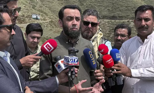 Pakistan's Information Minister Attaullah Tarar, center, briefs journalists during a government's organised trip for media to Bella Noor Shah, a mountainous village near Muzaffarabad, the capital of Pakistan administered Kashmir, Monday, May 5, 2025. (AP Photo/Muhammad Yousuf, Pool)