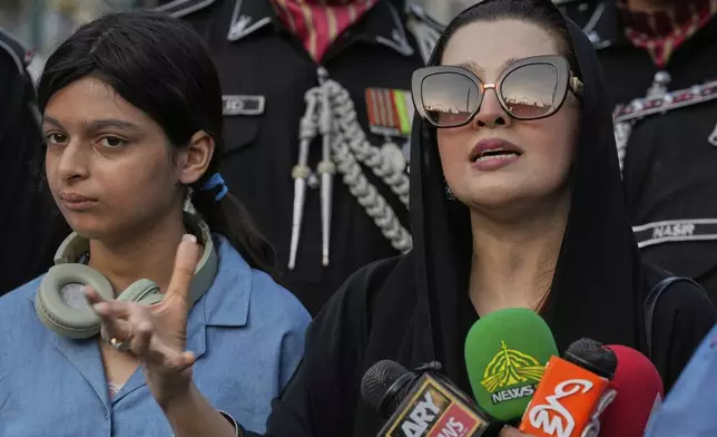 Mushaal Hussein, right, the wife of a top Kashmiri rebel leader, Mohammed Yasin Malik, talks to media as her daughter Razia Sultan watches, at the Wagah, a joint post on the Pakistan and India border, near Lahore, Pakistan, Monday, May 5, 2025. (AP Photo/K.M. Chaudary)