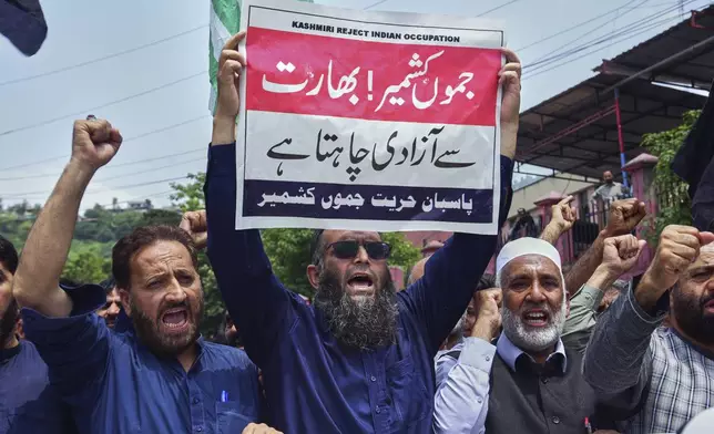 Supporters of Pasban-e-Hurriyat Jammu and Kashmir chant slogans during an anti-India demonstration, in Muzaffarabad, the capital of Pakistan administered Kashmir, Monday, May 5, 2025. The placard in the center reads "Jammu and Kashmir want idepdendenoe from India". (AP Photo/M.D. Mughal)