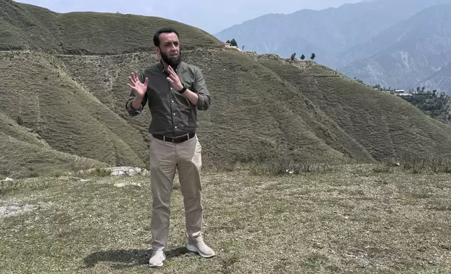 Pakistan's Information Minister Attaullah Tarar, center, briefs journalists during a government's organized trip for media to Bella Noor Shah, a mountainous village near Muzaffarabad, the capital of Pakistan administered Kashmir, Monday, May 5, 2025. (AP Photo/Muhammad Yousuf, Pool)