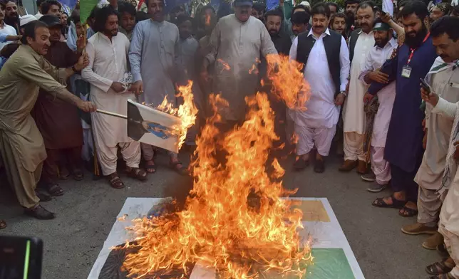 Supporters of Muttahida Qabail Federation party burn a rendition of the Indian flag and poster with the picture of Indian Prime Minister Narendra Modi during a demonstration in Quetta, Pakistan, Sunday, May 4, 2025. (AP Photo/Arshad Butt)