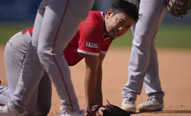 Los Angeles Angels starting pitcher Yusei Kikuchi looks toward his dugout after colliding with Los Angeles Dodgers' Tommy Edman while trying to force him out at first during the sixth inning of a baseball game Sunday, May 18, 2025, in Los Angeles. (AP Photo/Mark J. Terrill)