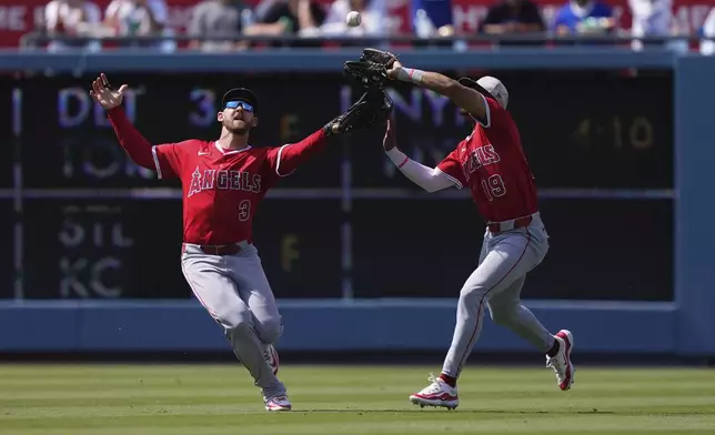 Los Angeles Angels' Kyren Paris, right makes a catch on a ball hit by Los Angeles Dodgers' Mookie Betts as Taylor Ward collides with him during the seventh inning of a baseball game Sunday, May 18, 2025, in Los Angeles. (AP Photo/Mark J. Terrill)