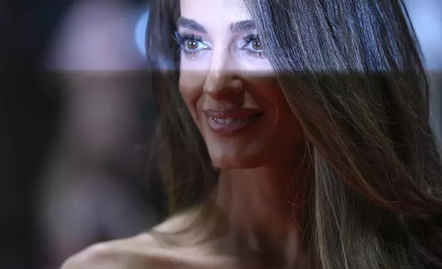Amal Clooney poses for photographers upon arrival at the premiere of the film 'Bono: Stories of Surrender' at the 78th international film festival, Cannes, southern France, Friday, May 16, 2025. (Photo by Lewis Joly/Invision/AP)