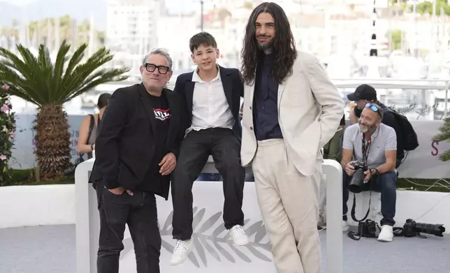 Sergi Lopez, from left, Bruno Nunez, and director Oliver Laxe pose for photographers at the photo call for the film 'Sirat' at the 78th international film festival, Cannes, southern France, Friday, May 16, 2025. (AP Photo/Natacha Pisarenko)