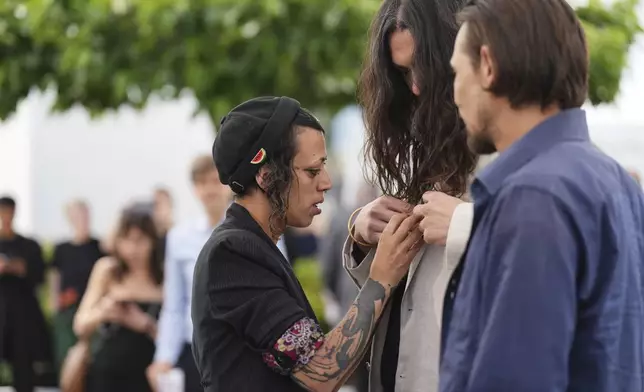 Jade Oukid, from left, director Oliver Laxe, and Tonin Janvier arrive at the photo call for the film 'Sirat' at the 78th international film festival, Cannes, southern France, Friday, May 16, 2025. (Photo by Lewis Joly/Invision/AP)